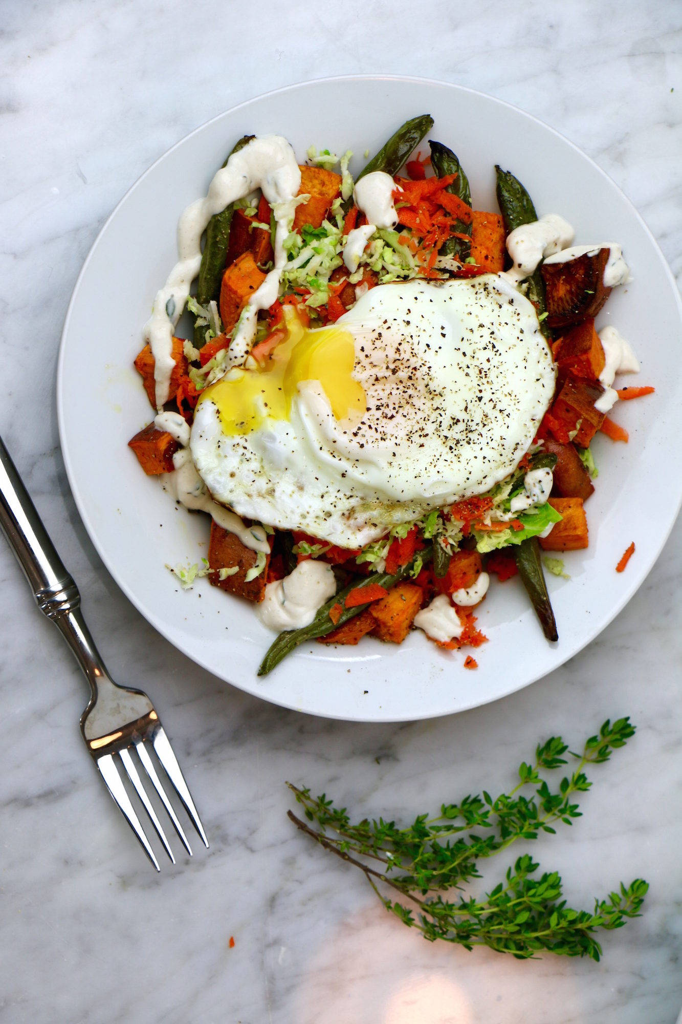 Buckwheat Breakfast Bowl with Savory Roasted Veggies, a Garlic Lemon Tahini Sauce, and a Fried Egg on top! This bowl is healthy, gluten-free, and vegetarian. Make it vegan by removing the egg.